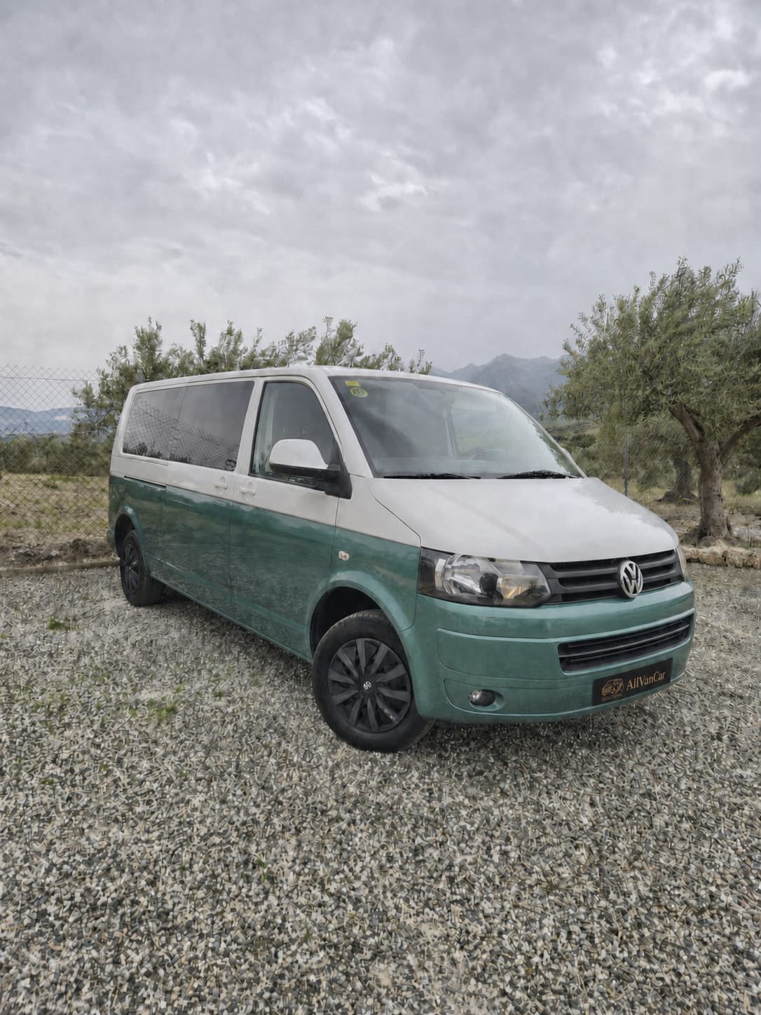 The same Volkswagen Transporter with a green-and-white two-tone finish, green bumpers, and dark wheels.